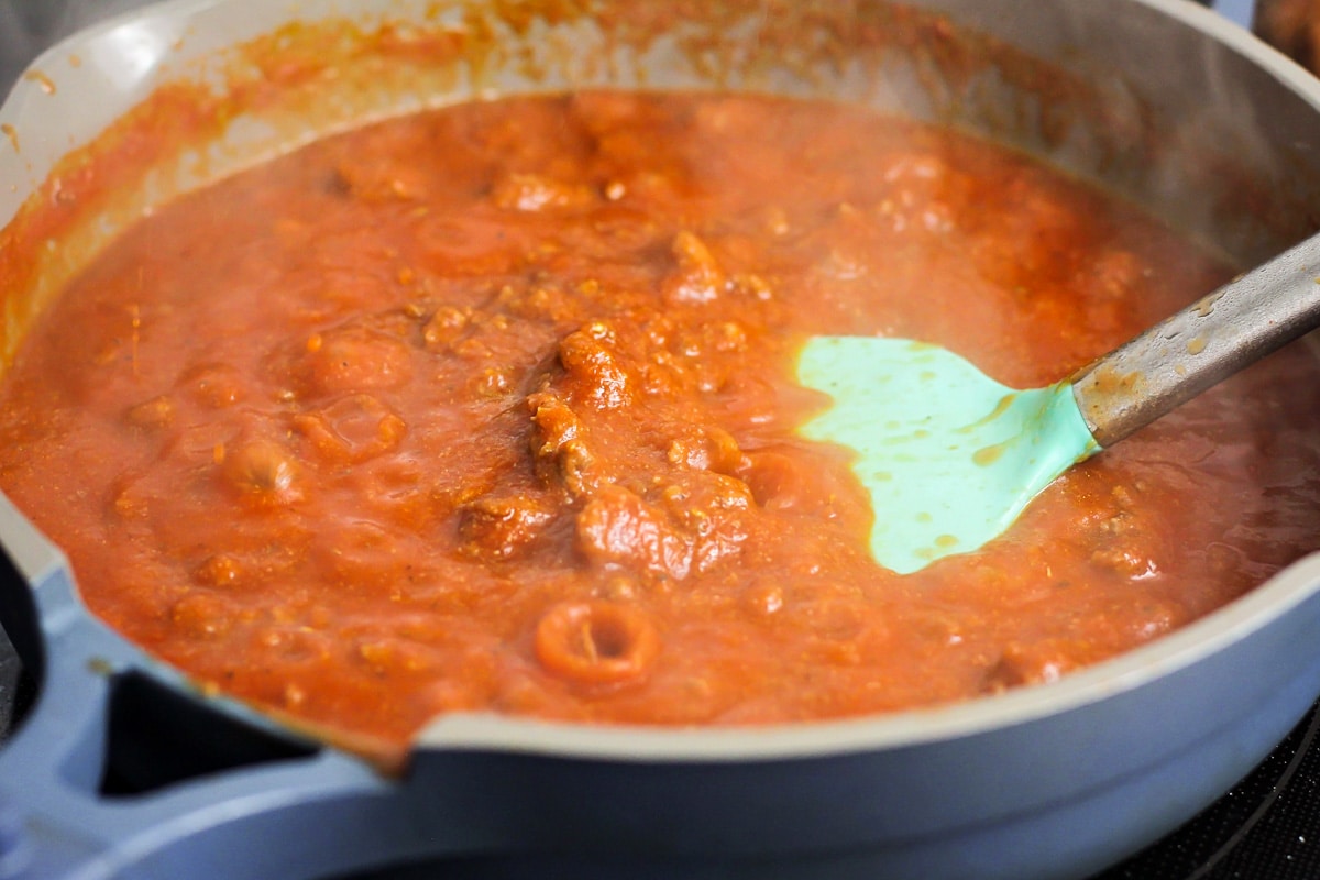 Spaghetti sauce in hamburger meat in skillet.