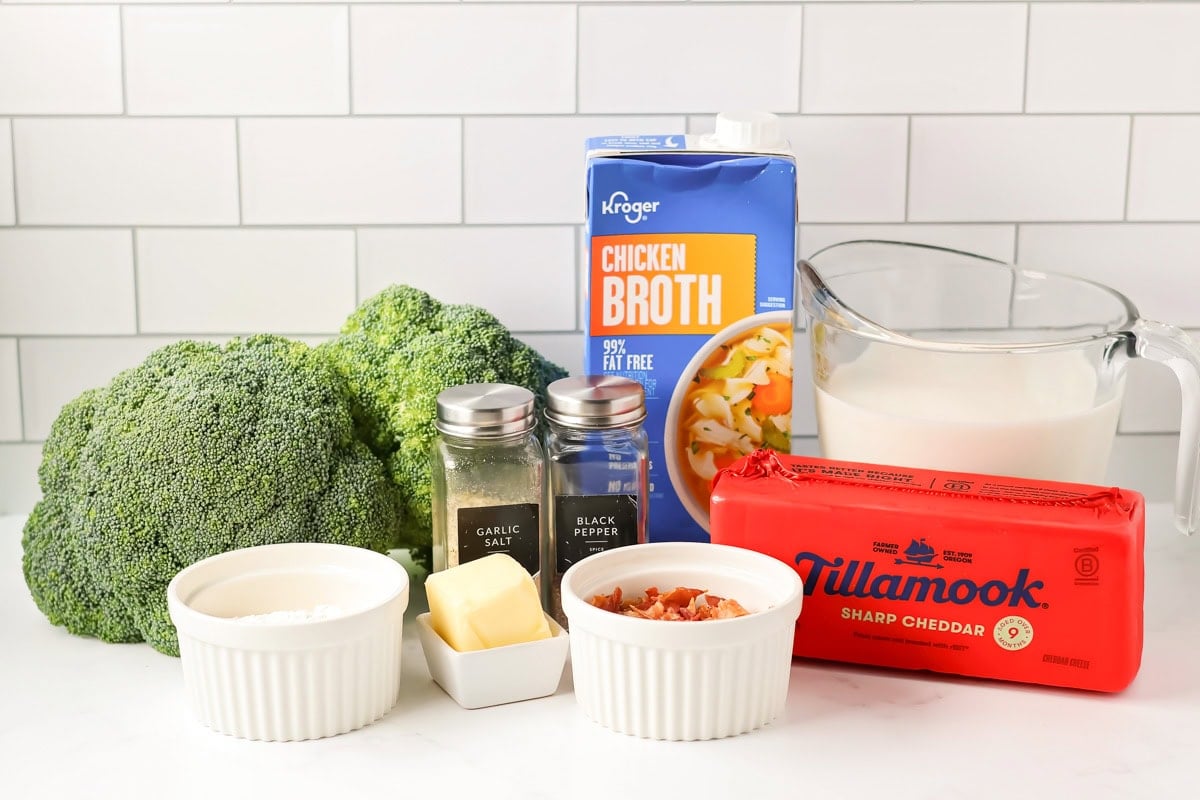 Ingredients for broccoli cheese soup on a kitchen counter.
