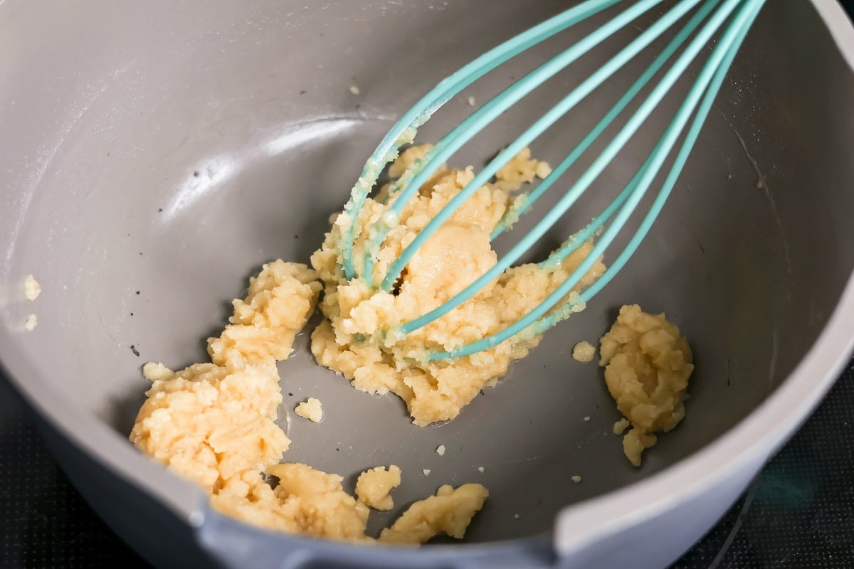 Whisking flour and butter for make broccoli cheese soup roux.