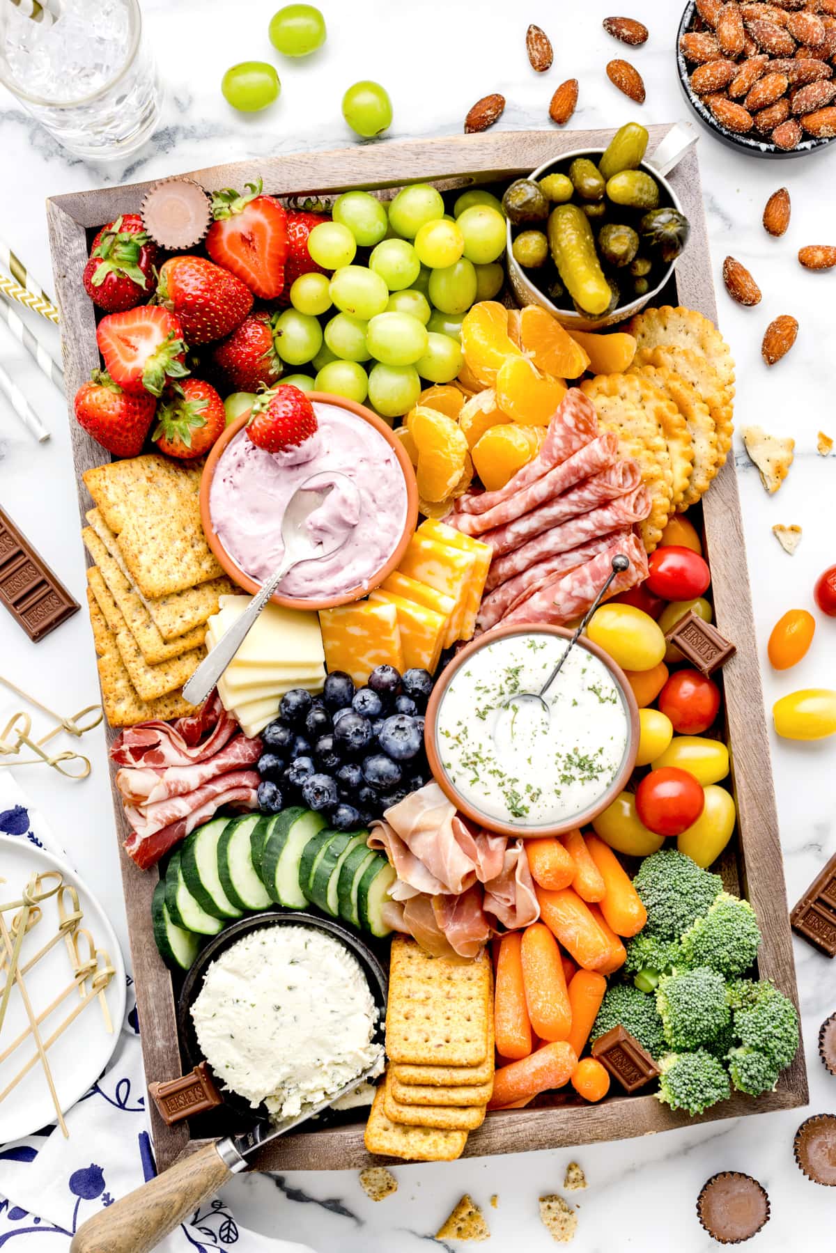 How to make a charcuterie board and fill it with your favorite things to snack on.