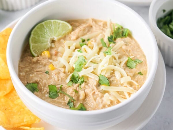 A bowl of chicken enchilada soup topped with fresh cilantro.