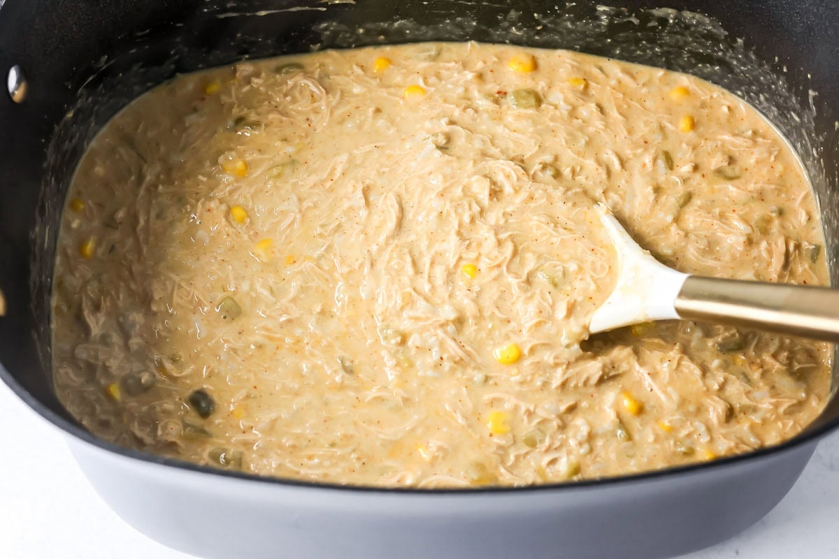 A crock pot filled with creamy chicken enchilada soup.