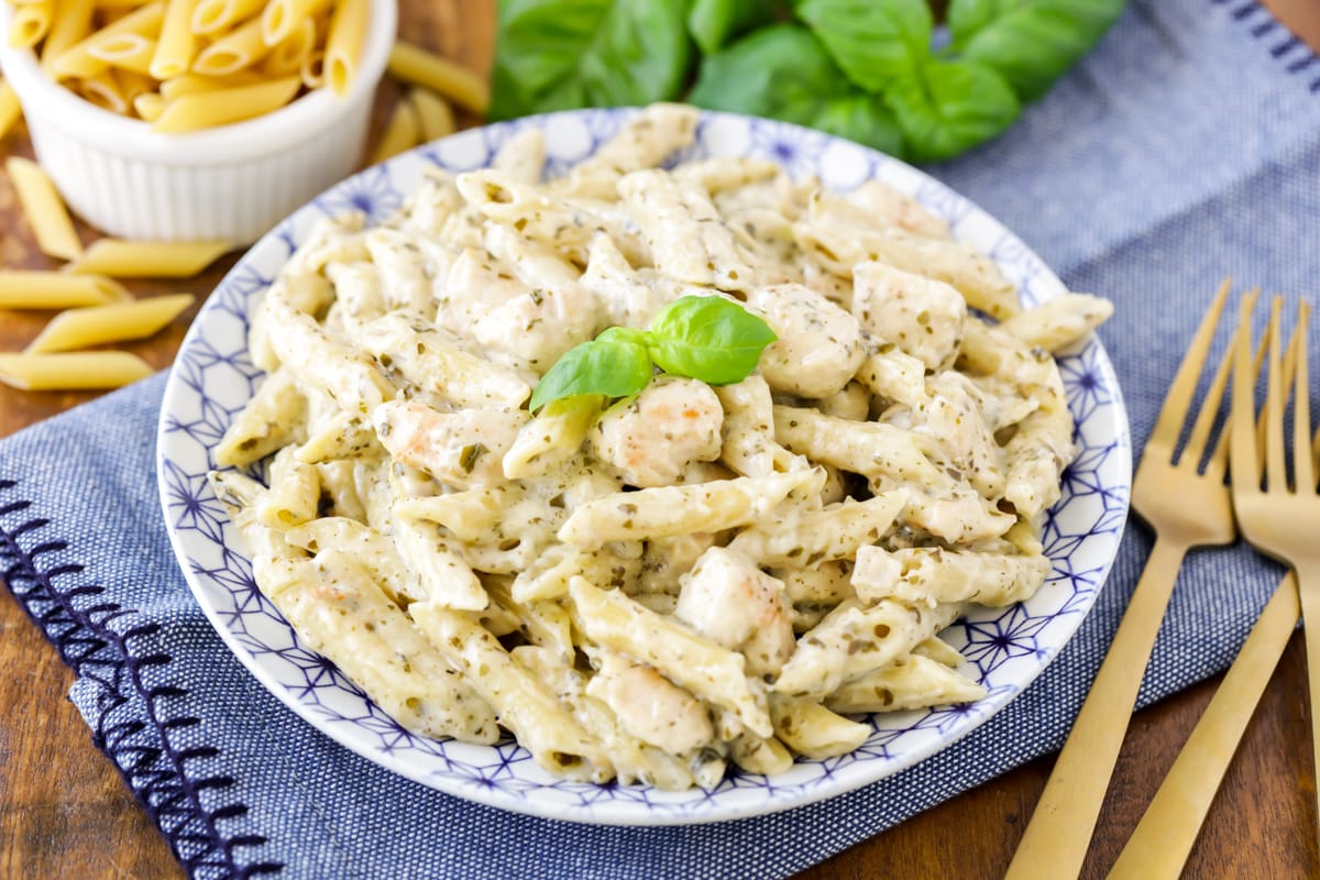 A plate filled with chicken pesto pasta.