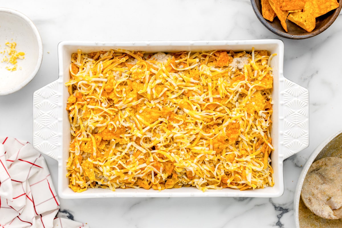 Shredded cheese on top of casserole in baking dish.