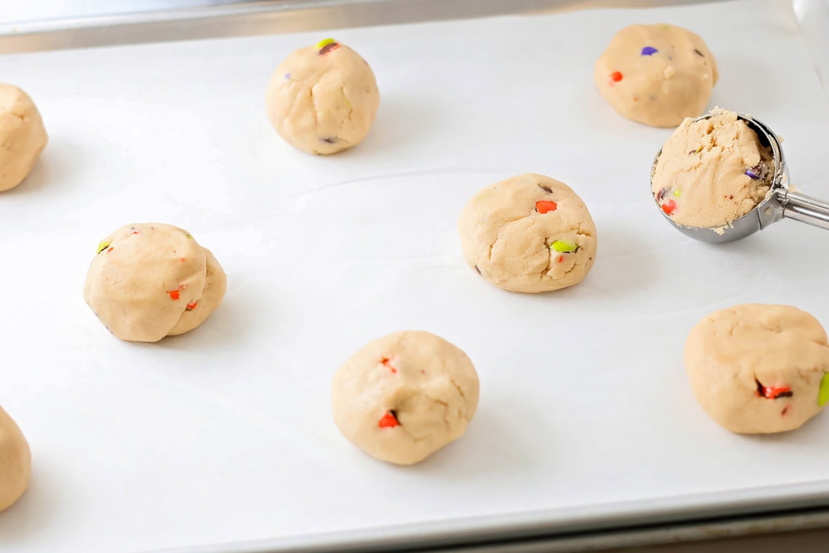 Halloween cookie dough balls on cookie sheet.