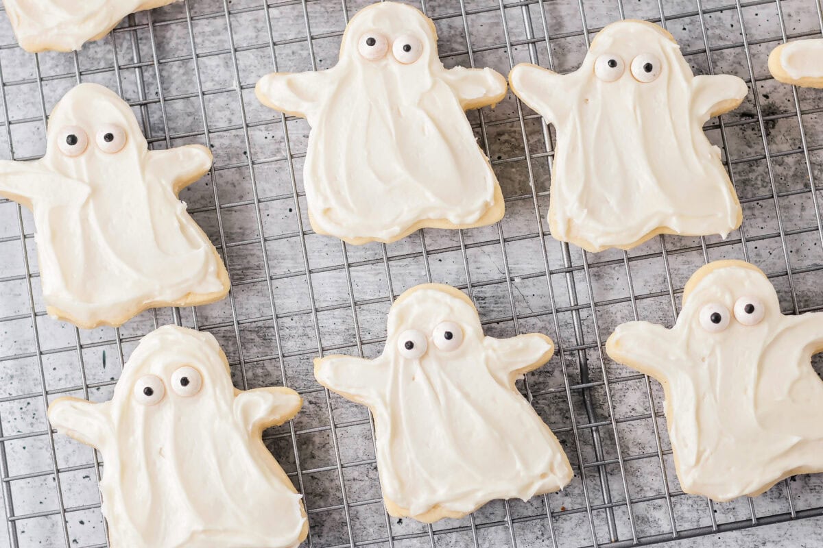 Ghost sugar cookies on cookie rack.