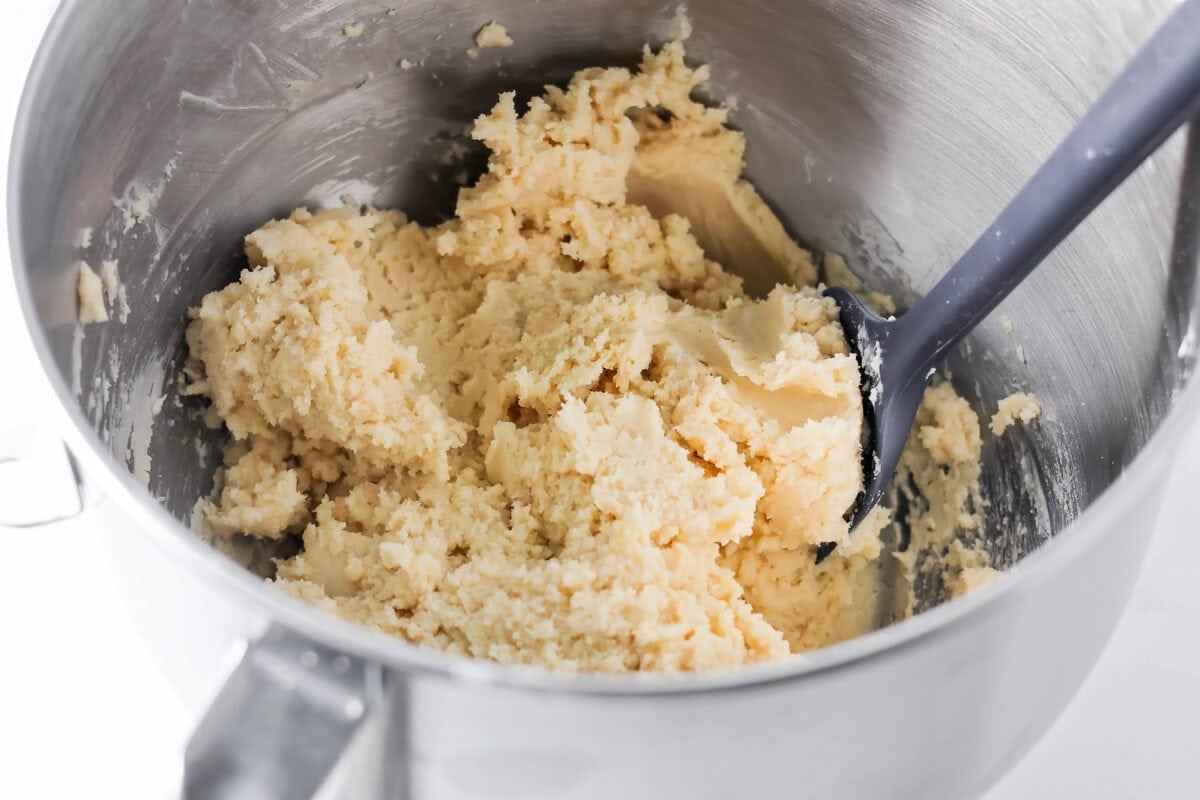 Sugar cookie dough mixed together in metal bowl.