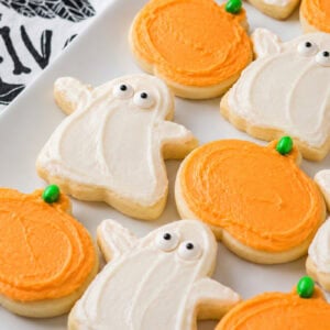 Halloween sugar cookies decorated on white plate.