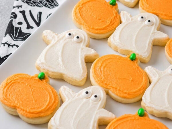 Halloween sugar cookies decorated on white plate.