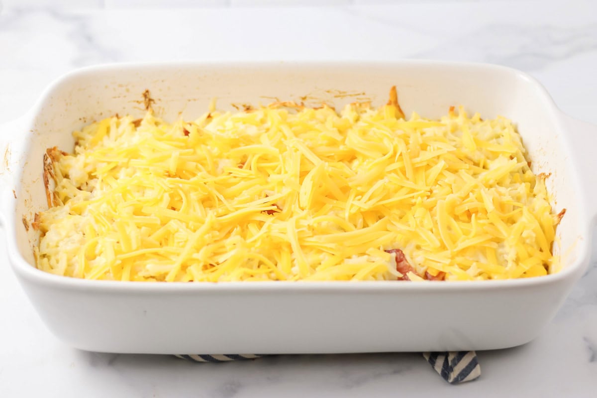 Cheese added on top of hashbrown casserole recipe.