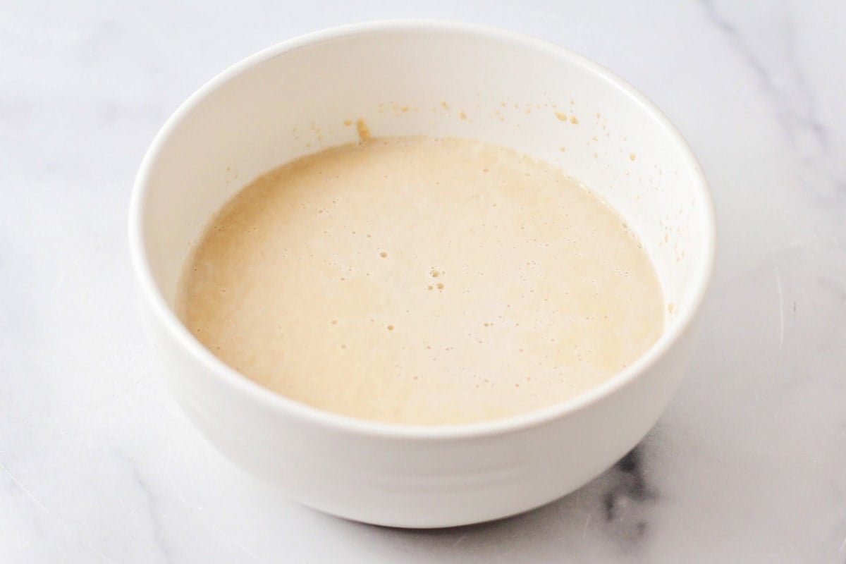 A white bowl filled with activated yeast.