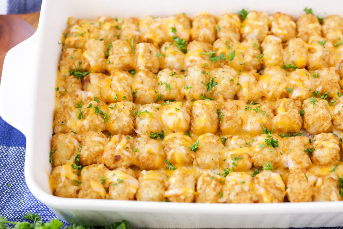 Top view of a white baking dish filled with cheesy tater tot casserole.
