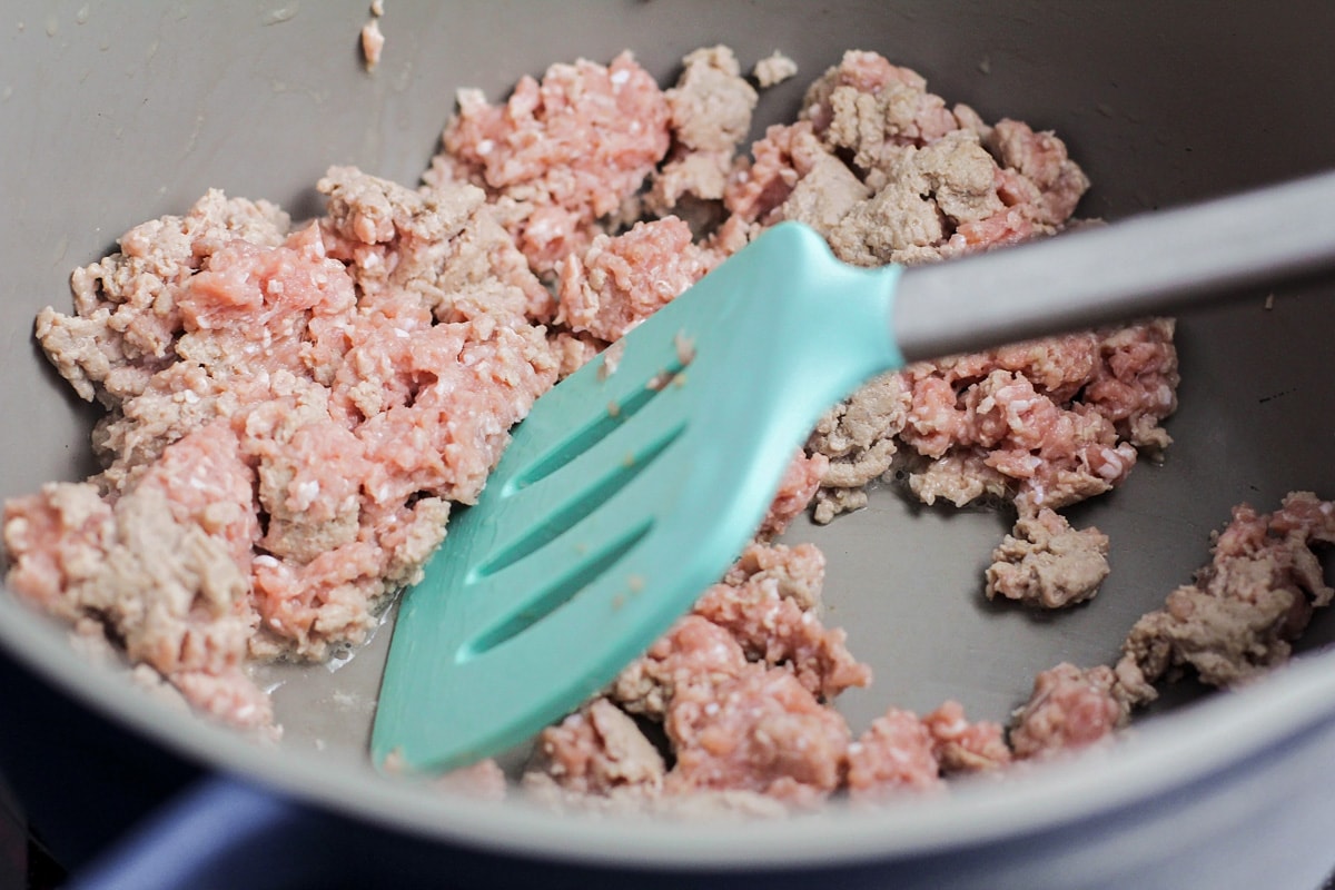 Ground turkey being cooked in pan.