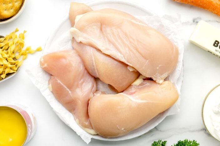Chicken breasts on white plate.