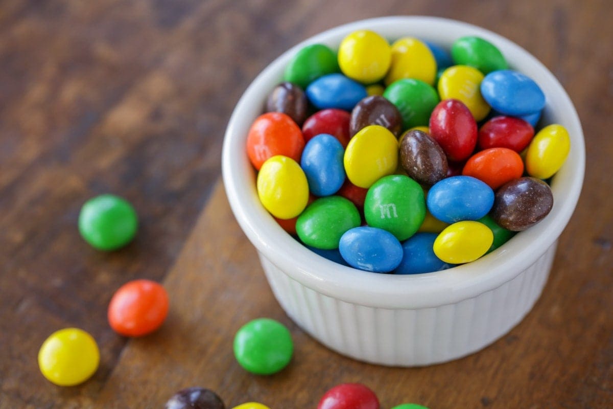 A white bowl of m&ms.