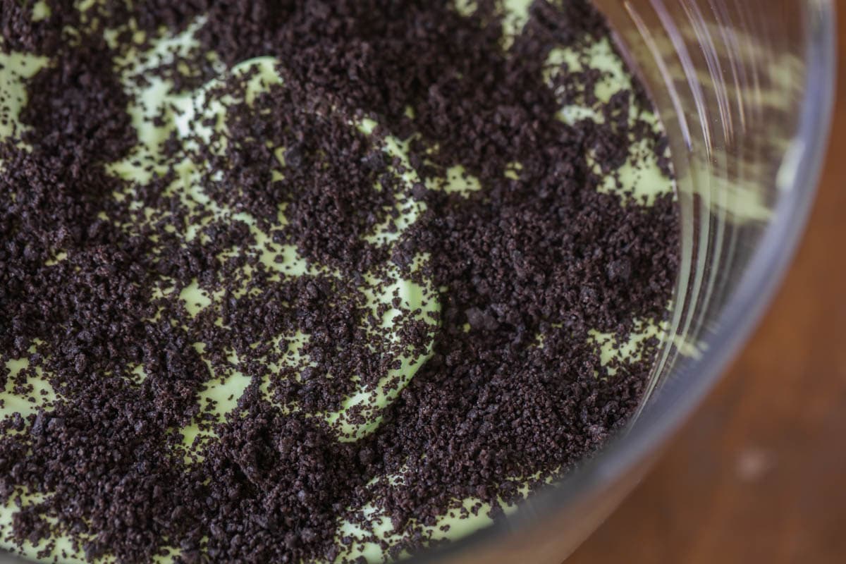 Oreos sprinkled on green layer for Oogie Boogie Trifle.