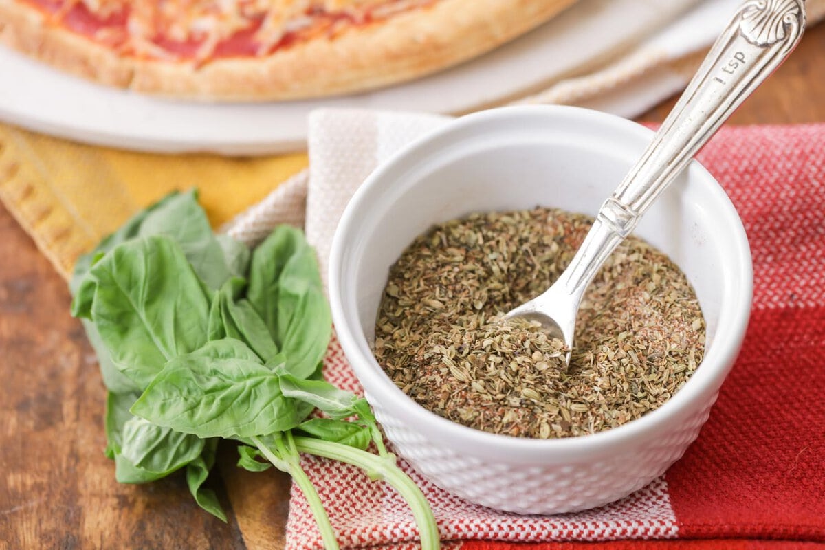 A white bowl of pizza seasonings.