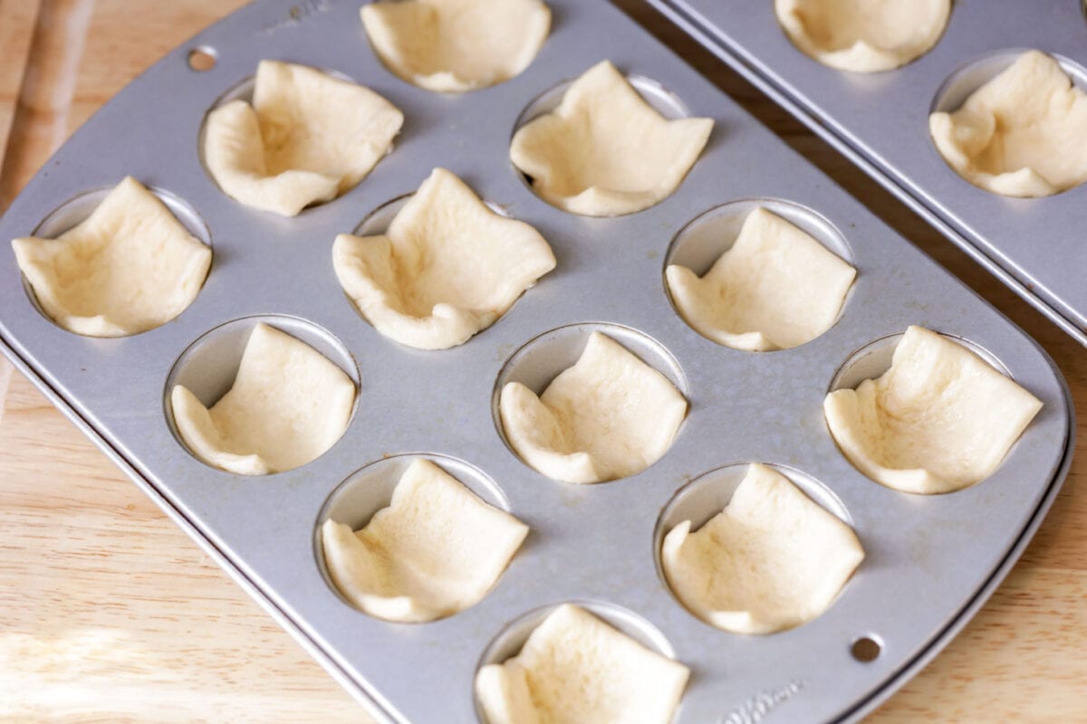 Crescent dough cut and put into mini muffin pans.