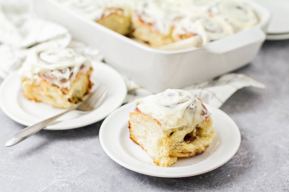 Frosted Cinnamon roll on plate.