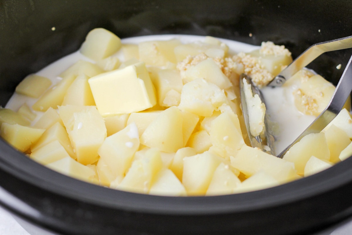 Slow cooker mashed potatoes process image.