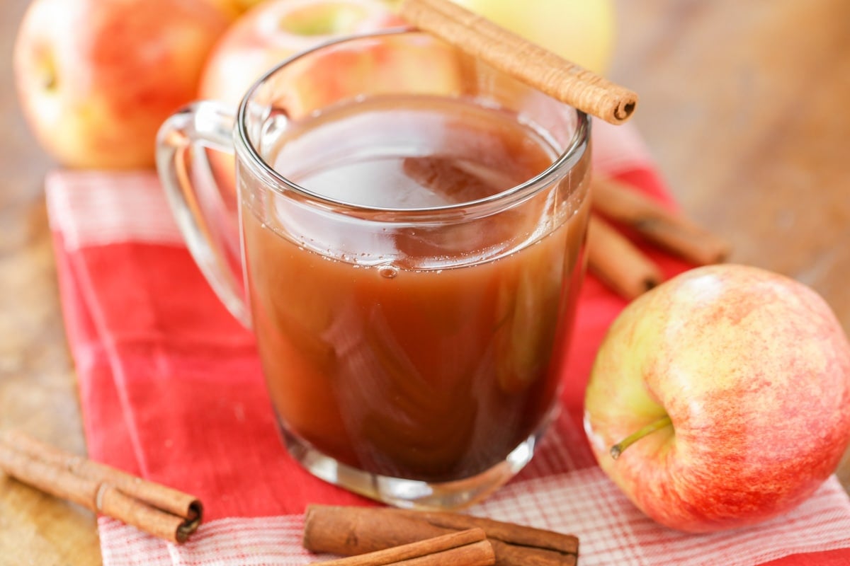 A glass mug filled with apple cider recipe.
