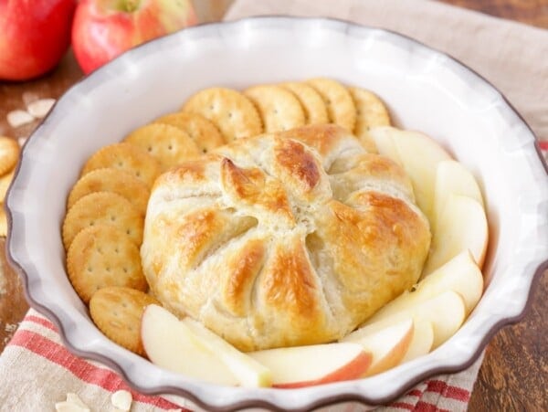 Baked brie in puff pastry served with crackers and apples.