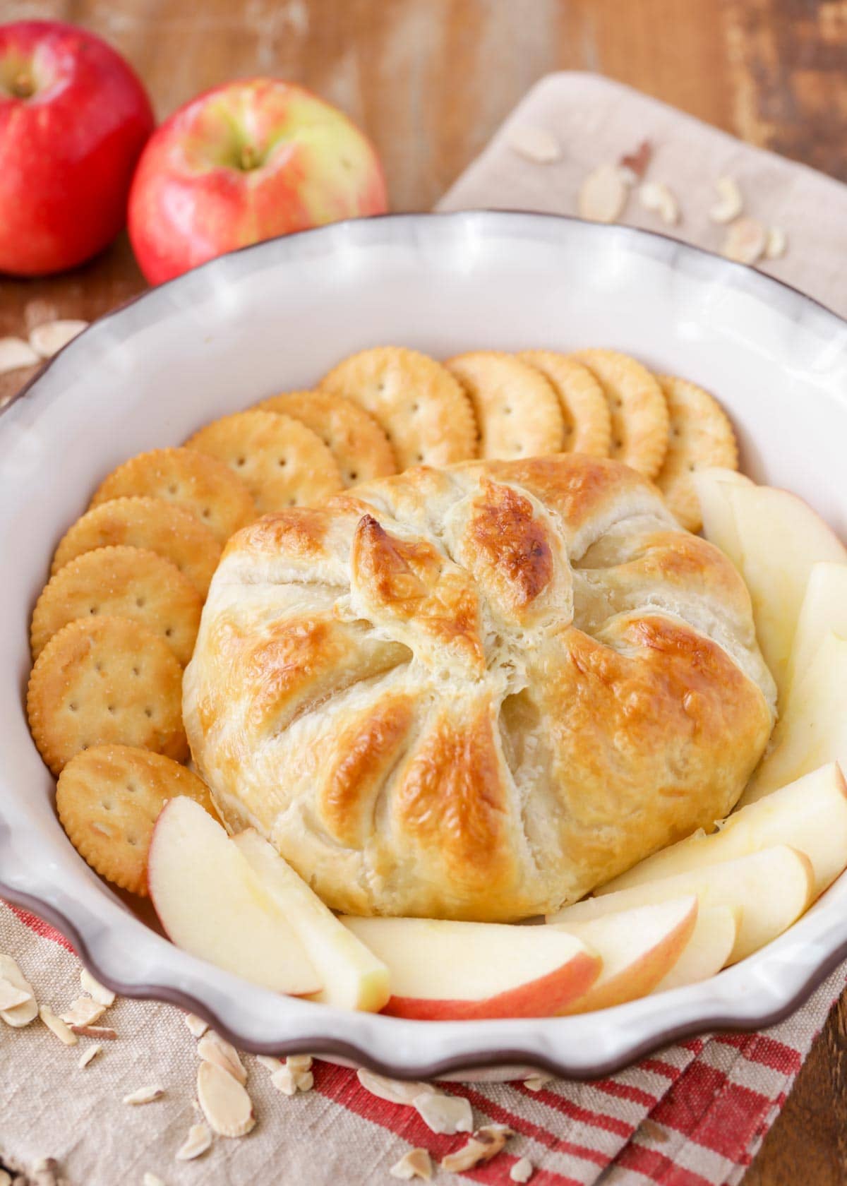 Baked brie in puff pastry served with apple slices and crackers.