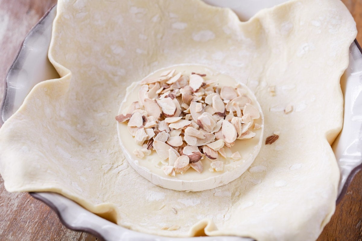 Brie wrapped in puff pastry and topped with almonds.