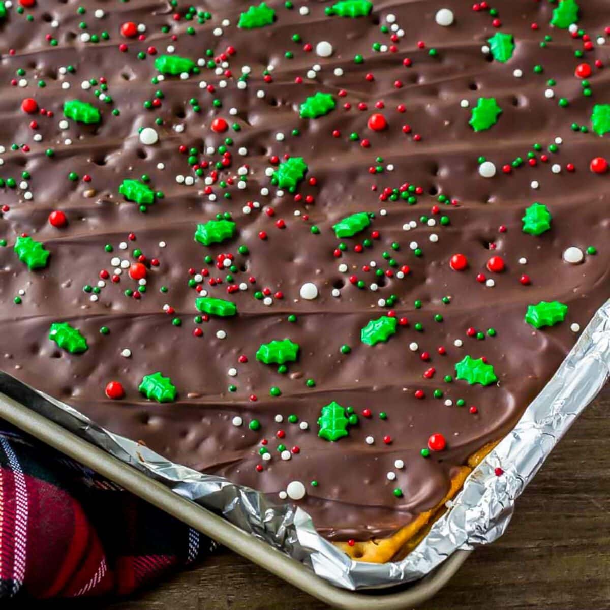 Chocolate covered cracker toffee topped with Christmas sprinkles.