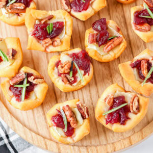 Cranberry Brie Bites are an easy holiday appetizer with creamy Brie, cranberry sauce, pecans, and flaky crescent dough in 30 minutes.