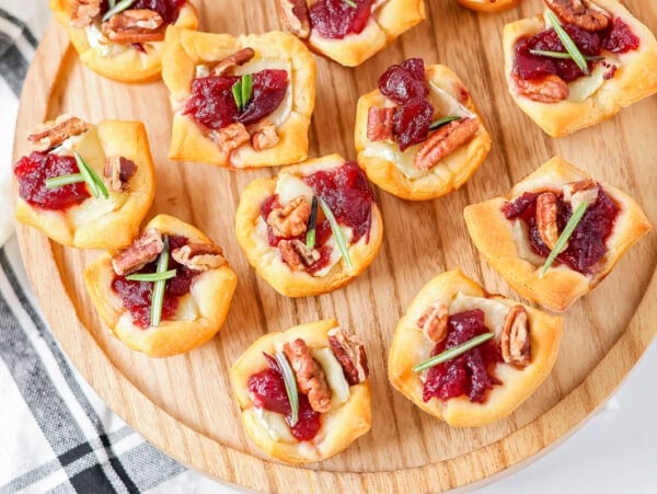 Cranberry Brie Bites are an easy holiday appetizer with creamy Brie, cranberry sauce, pecans, and flaky crescent dough in 30 minutes.