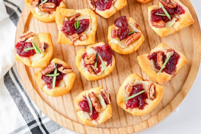 Cranberry Brie Bites are an easy holiday appetizer with creamy Brie, cranberry sauce, pecans, and flaky crescent dough in 30 minutes.