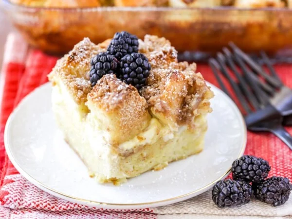 French Toast casserole with cream cheese slice on white plate.