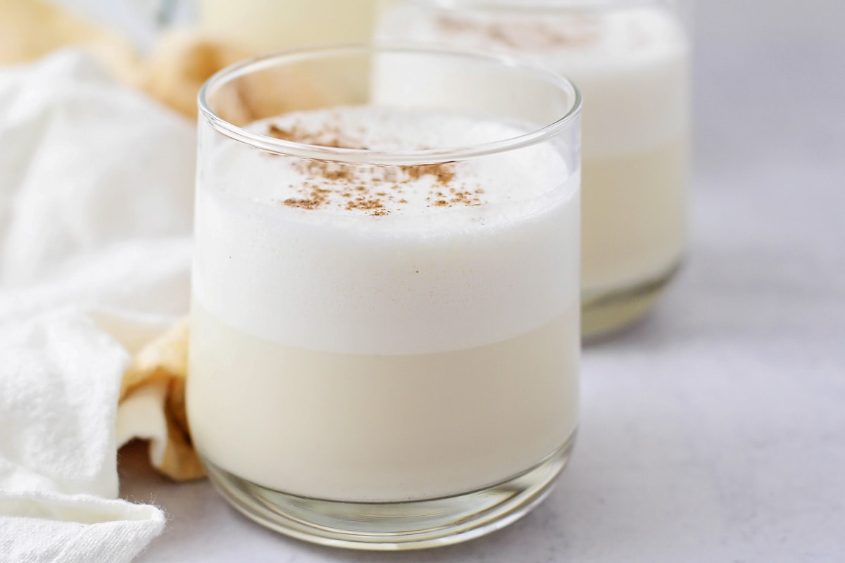 Homemade eggnog in glass cup.
