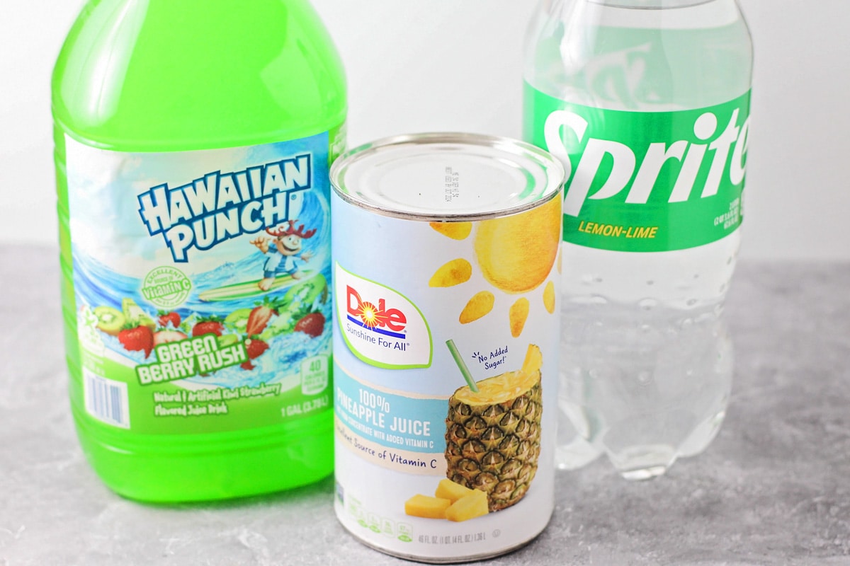 Sprite, Hawaiian Punch, and pineapple juice set out on a kitchen counter.