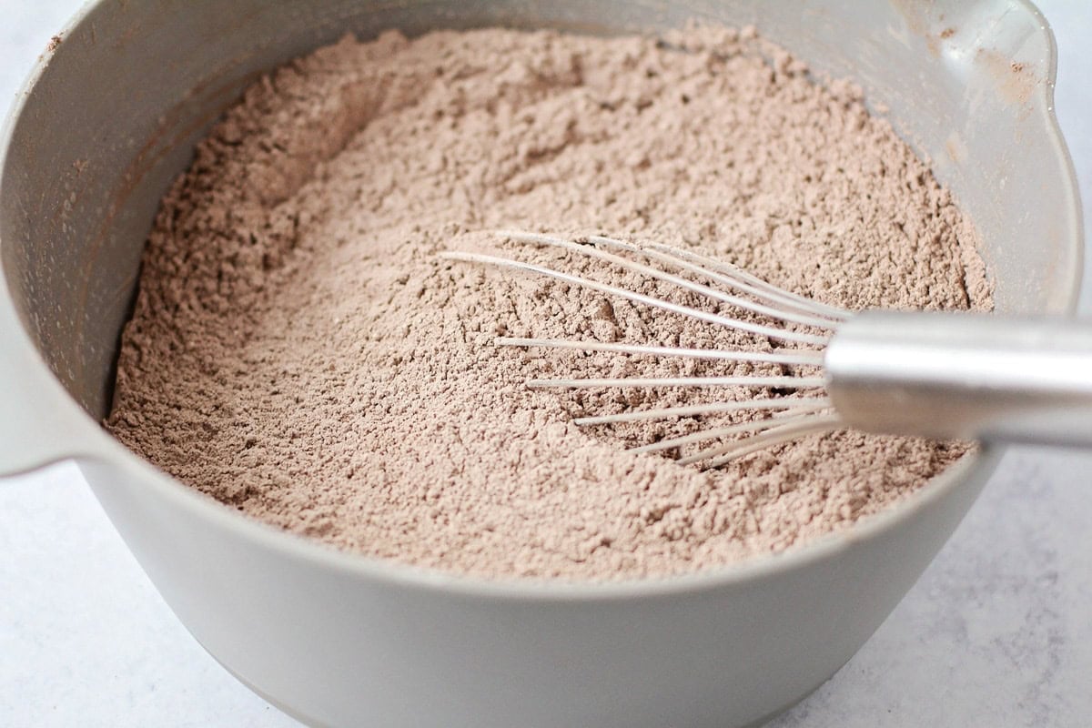 Cocoa powder and other ingredients mixed in a gray bowl.