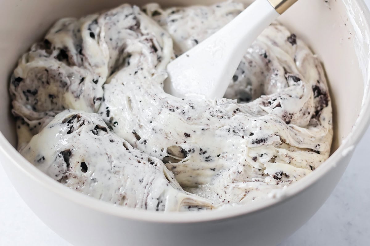 Mixing oreo fudge in a bowl.