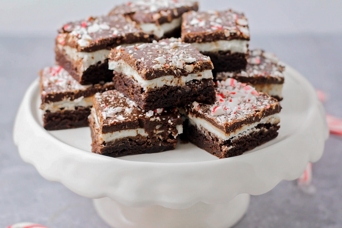 Peppermint Brownies stacked on white cake stand.