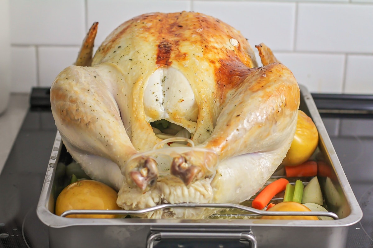 Turkey semi-roasted in roasting pan.