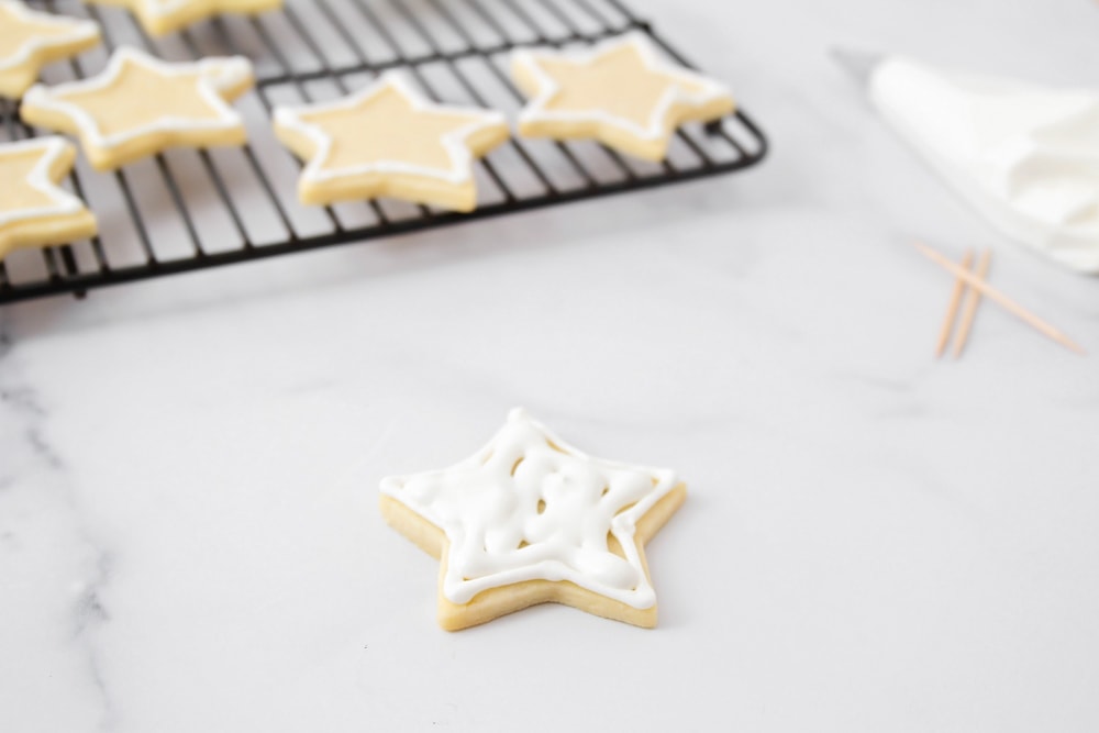 Royal icing setting on a sugar cookie.