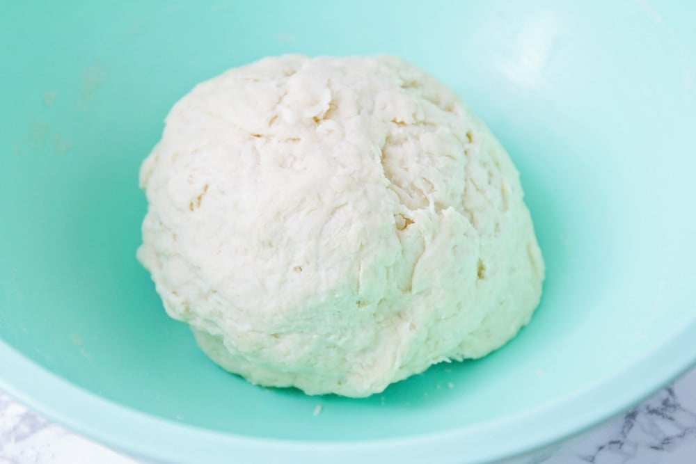 Sopapilla dough in a blue bowl.