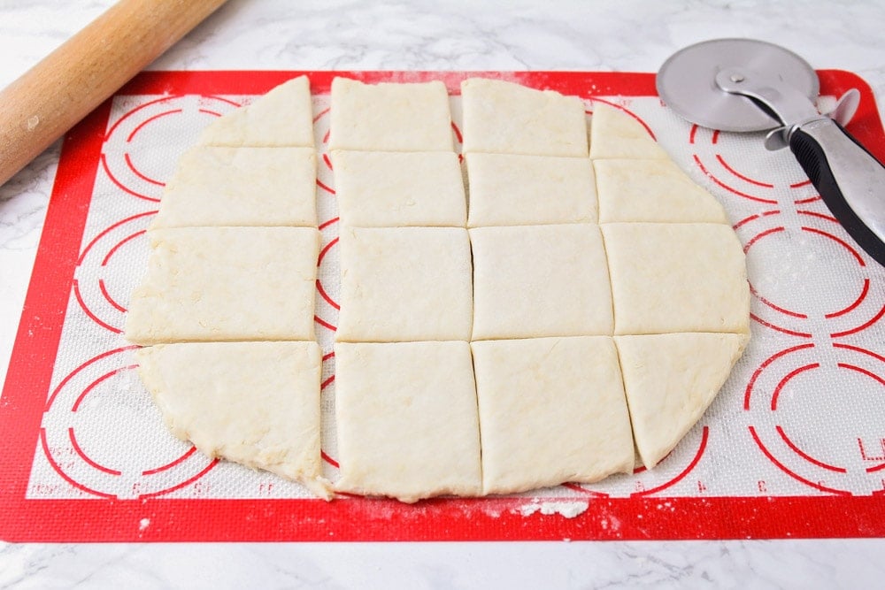 Sopapilla dough cut into squares.