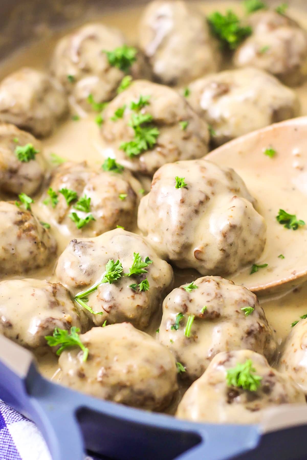 Swedish meatball recipe topped with parsley in sauce.