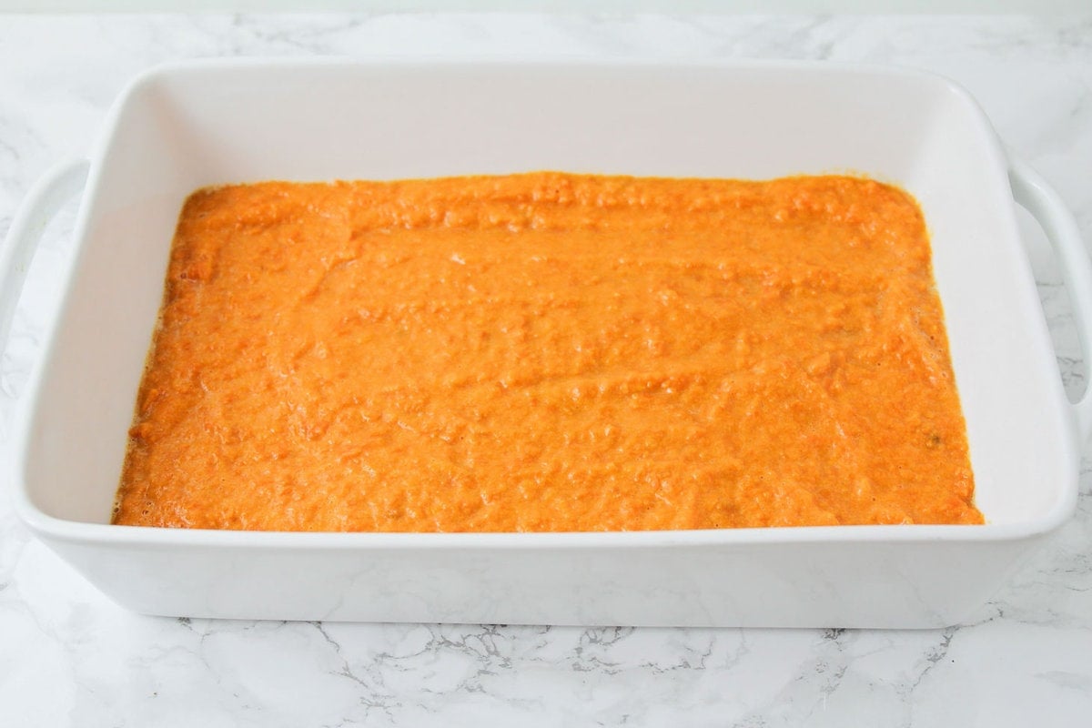 Creamed sweet potatoes spread in baking dish.
