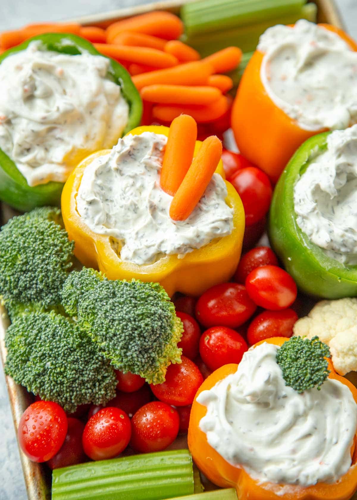 Bell peppers filled with dips and served with fresh veggies.