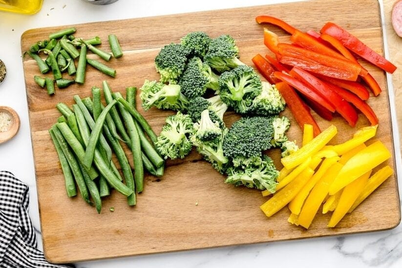 Various chopped veggies on a wood cutting board.