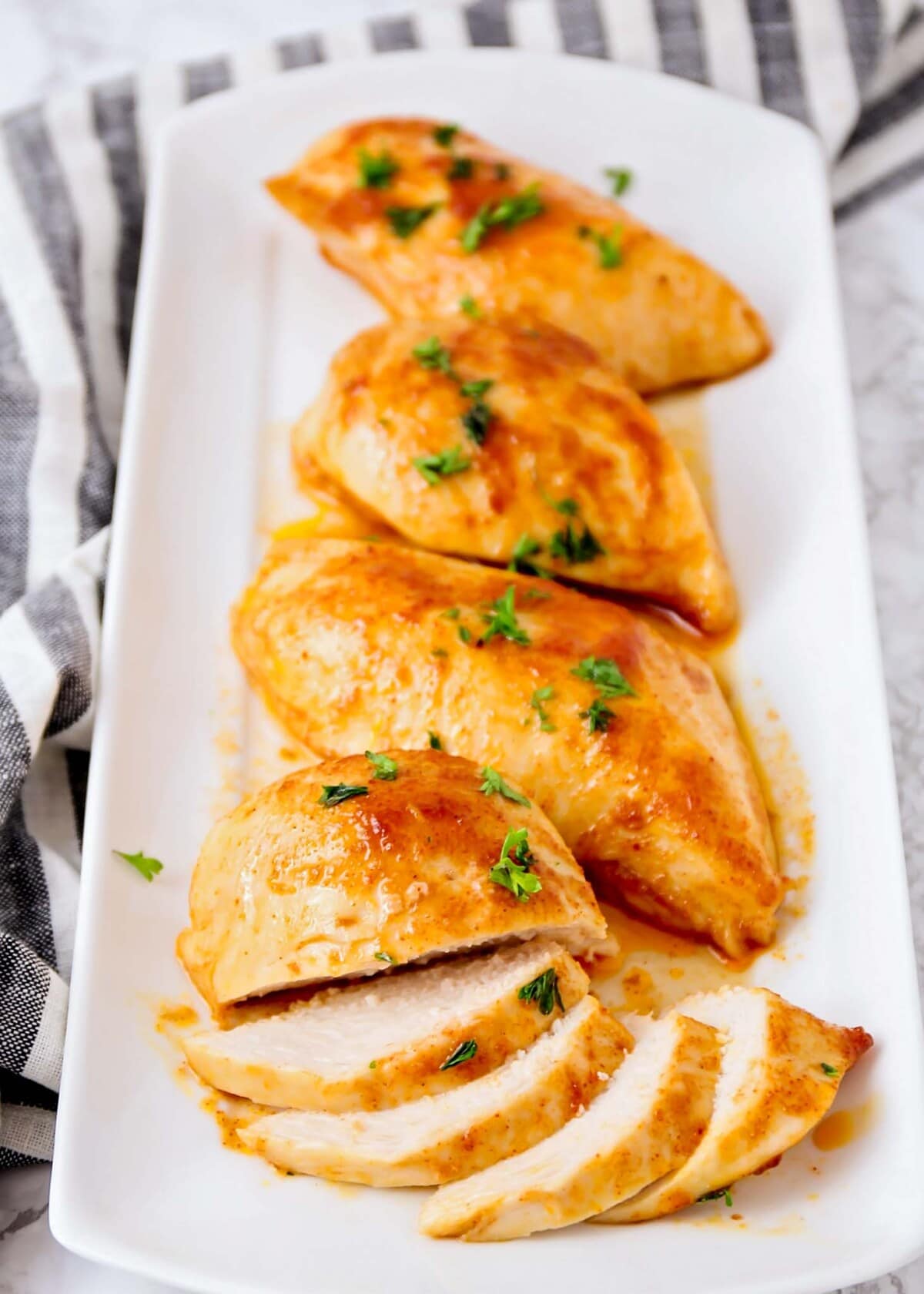 Oven baked bbq chicken breasts served on a platter.