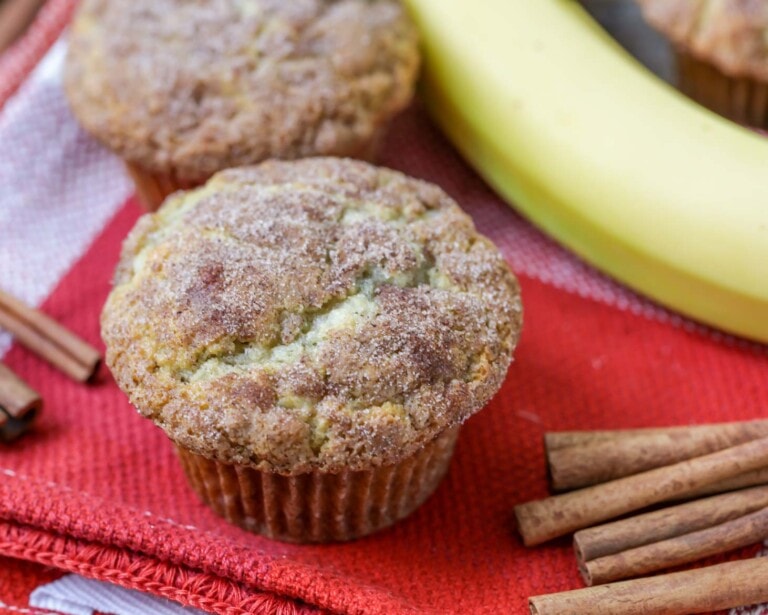 Homemade banana muffins on a tea towel.
