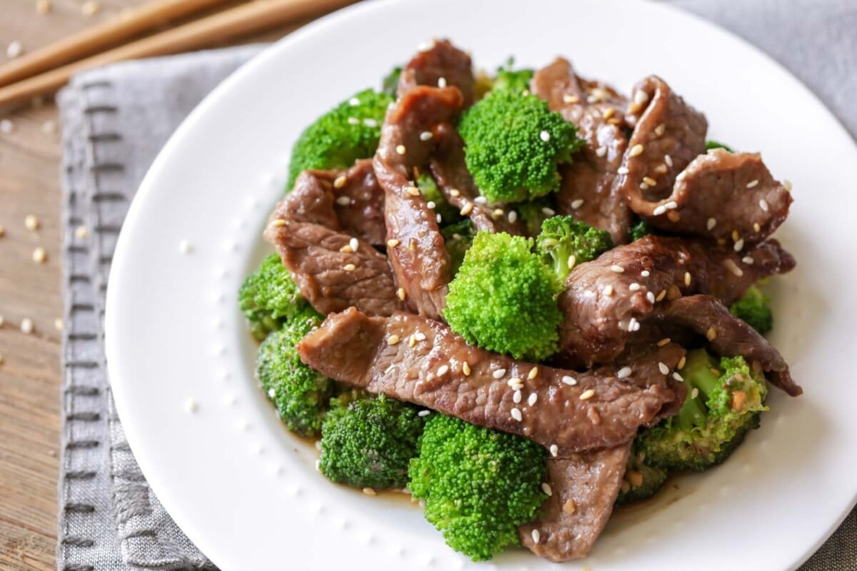Beef and broccoli stir fry on white plate.