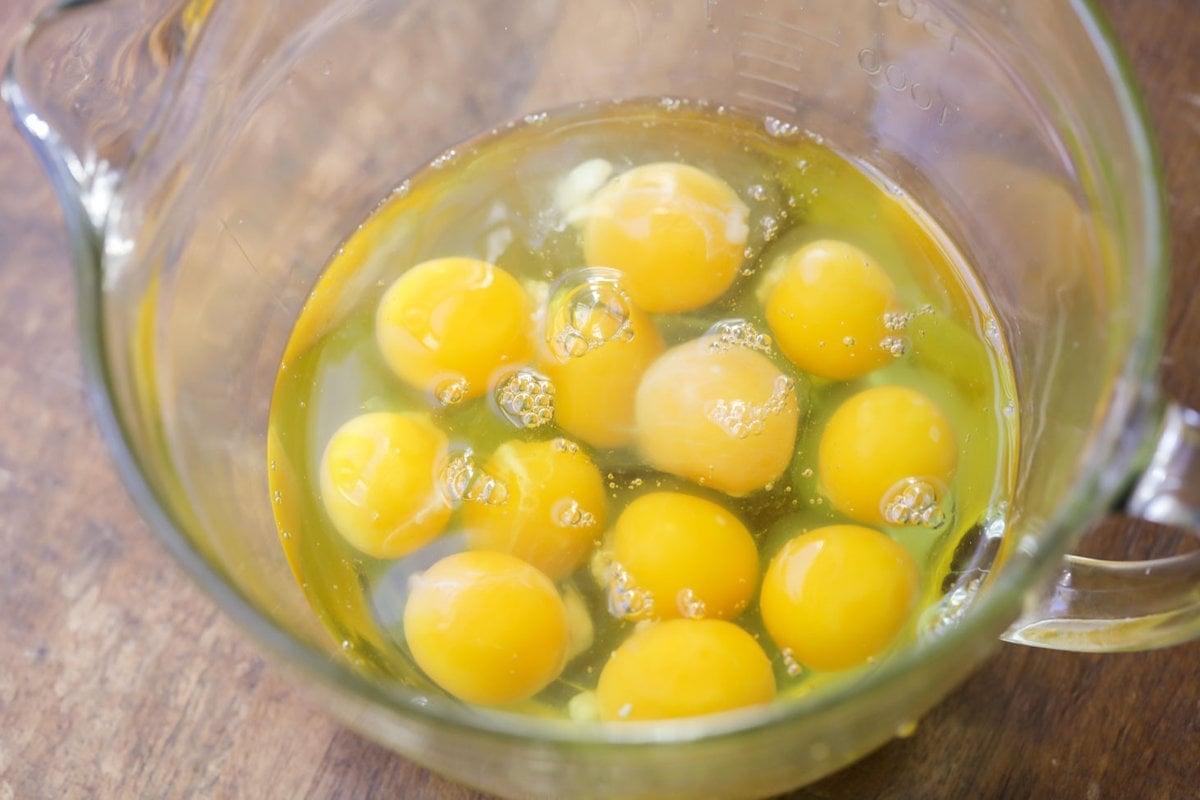 A glass bowl filled with cracked eggs.